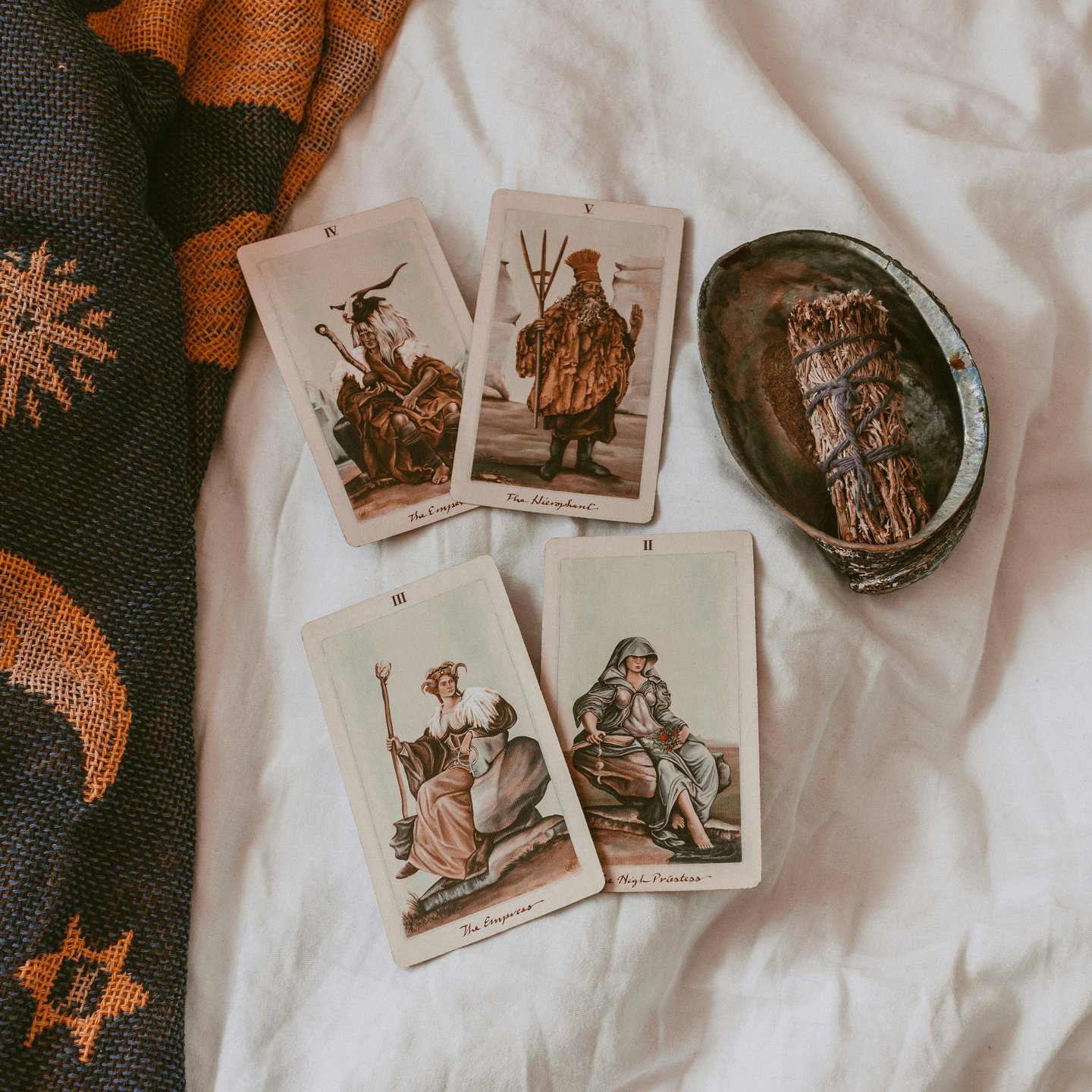 Tarot cards and sage bundle. Photo by Cat Crawford on Unsplash.