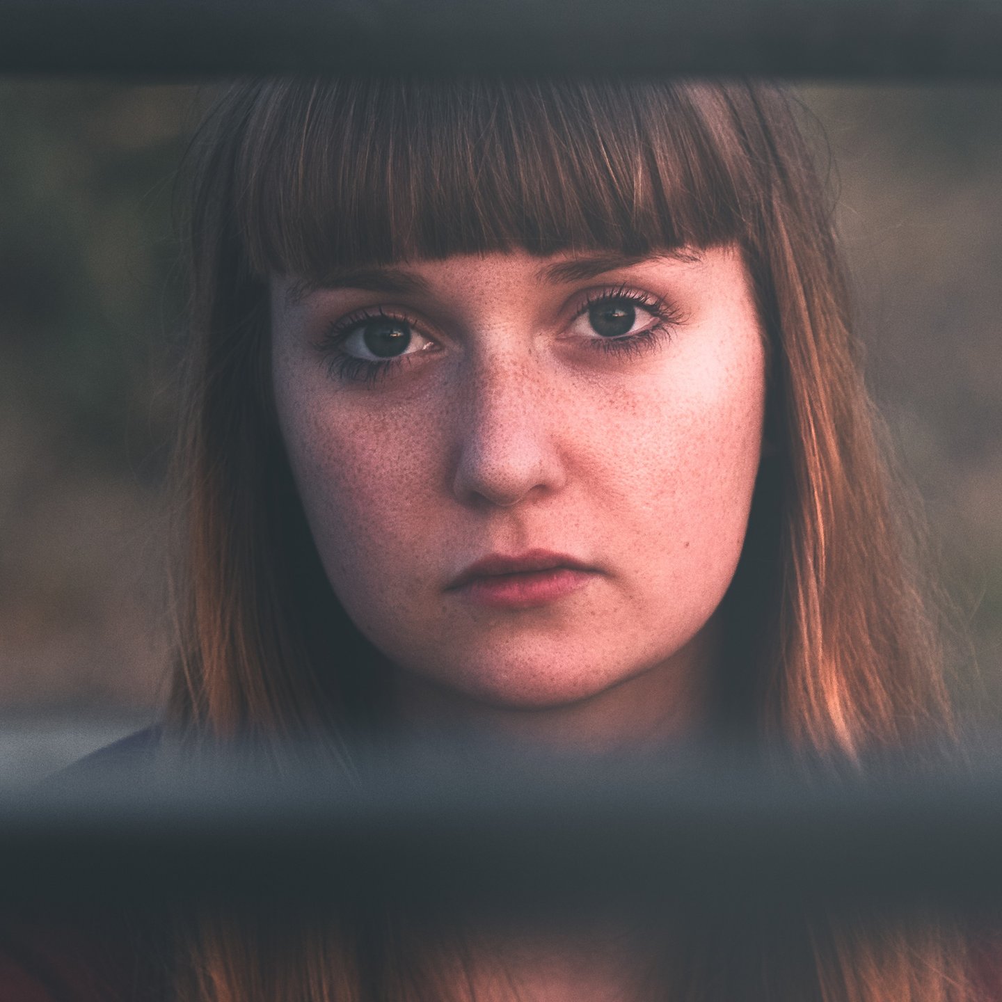 close up of a women with long hair and visible freckles