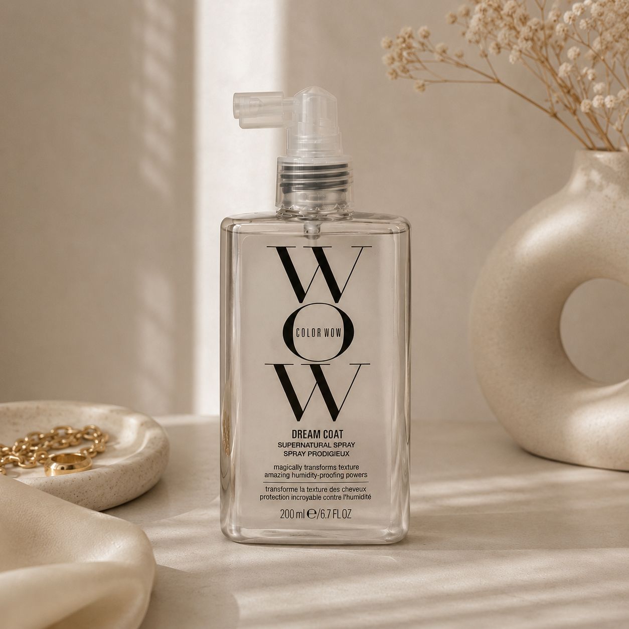 Color Wow Dream Coat Supernatural Spray styled in a beige luxury aesthetic.