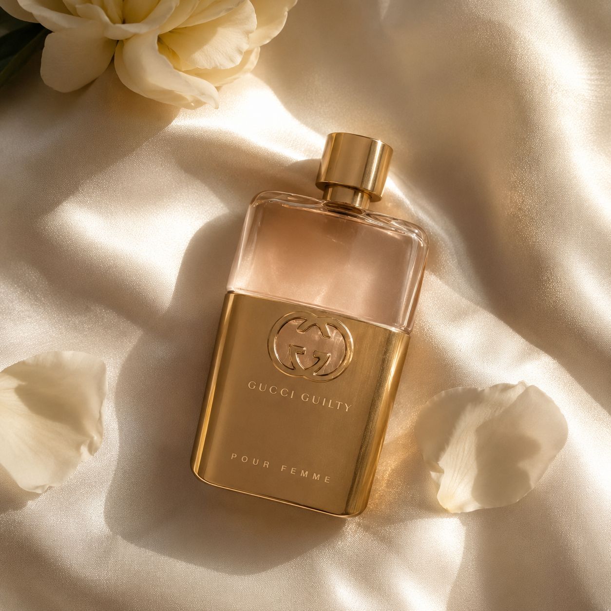 Gucci Guilty Pour Femme perfume bottle on soft white fabric with warm natural lighting