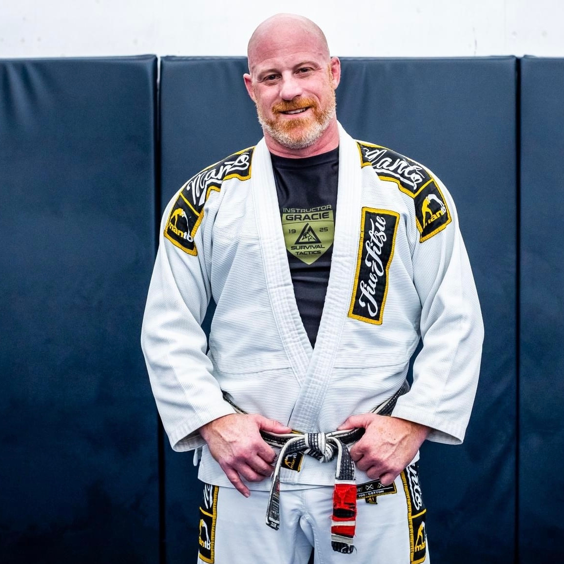 a man in a white gi and bjj black belt
