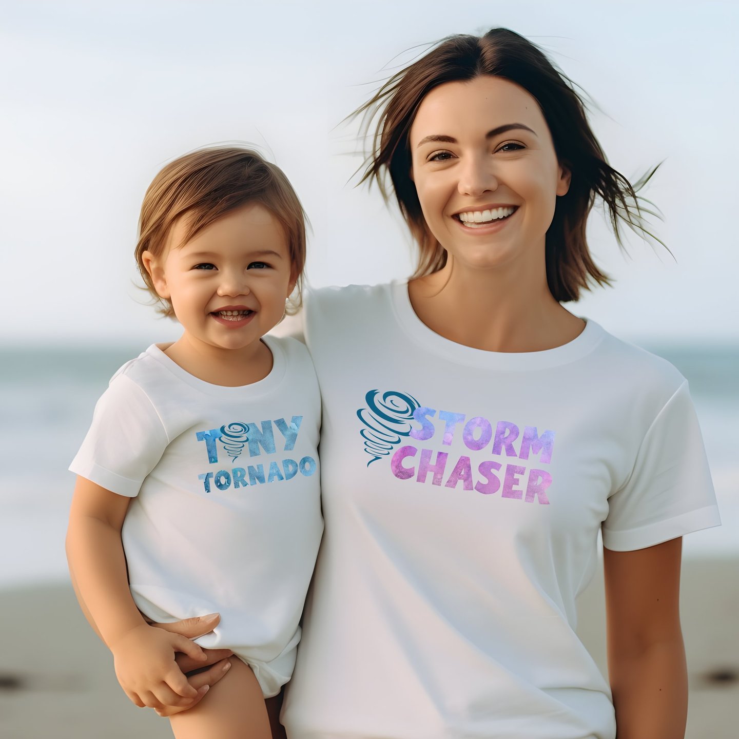 A toddler and his mother in matching shirts. His reads "Tiny Tornado" and hers "Storm Chaser."