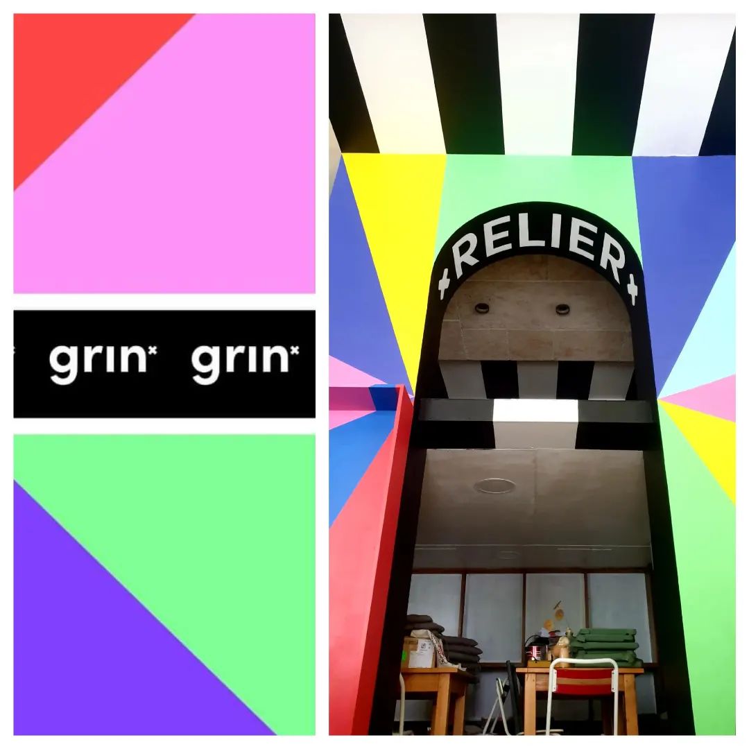 une fresque avec des triangles de couleurs vives et des inscriptions noir et blanches