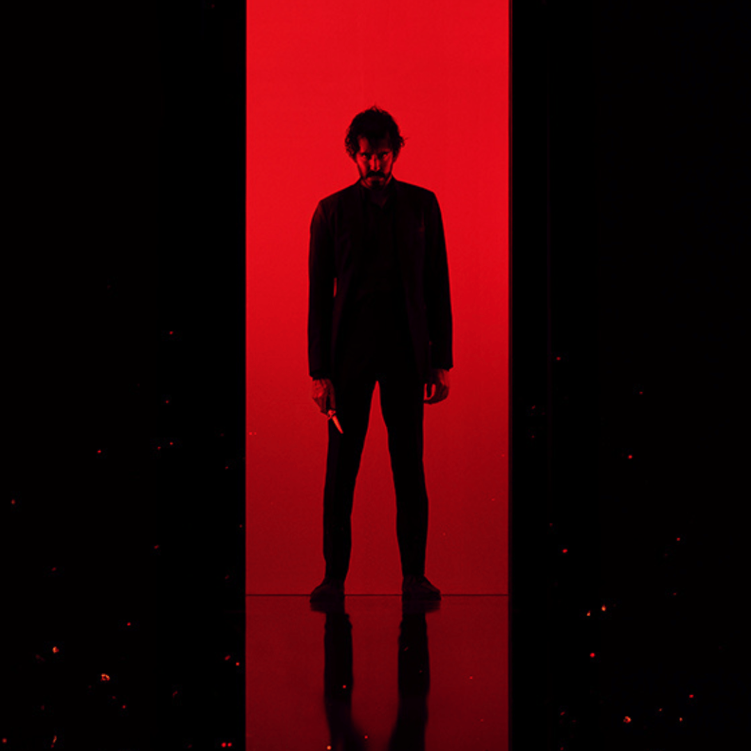 a man in a batman costume is standing in front of a store