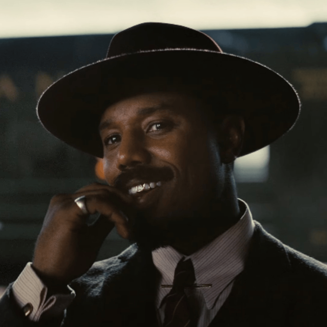 a man in a suit and tie is talking on a cell phone