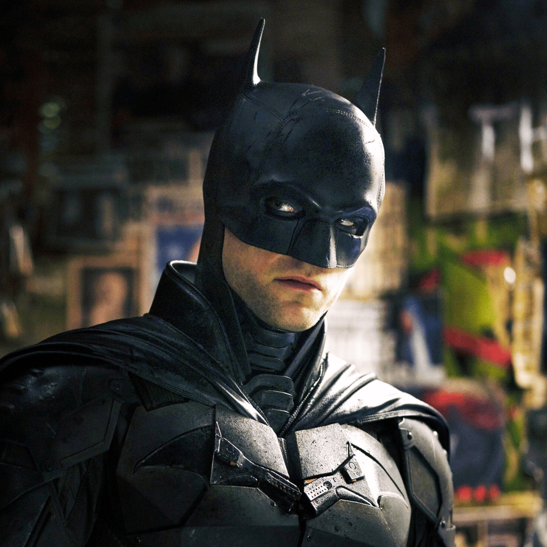 a man in a suit and hat holding a hat