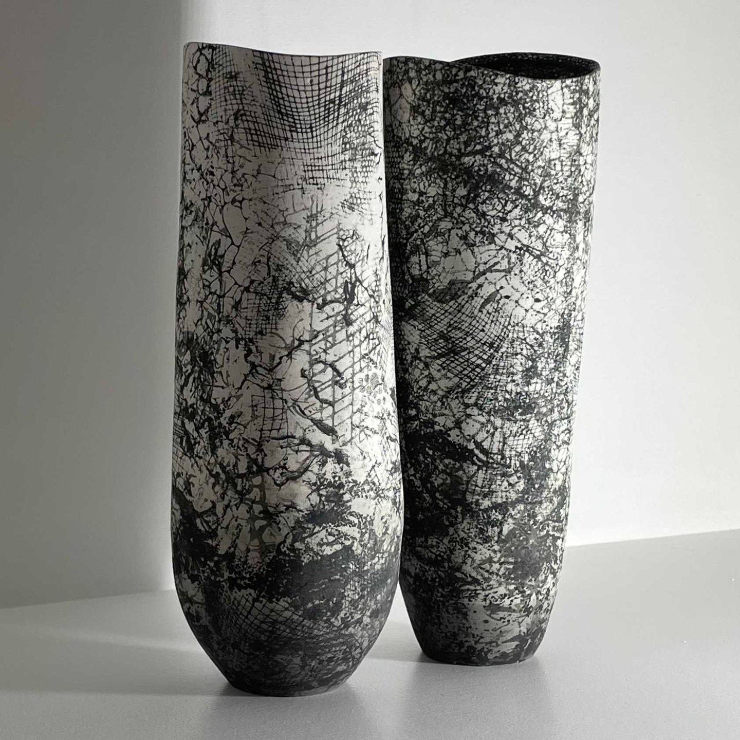 Two classically designed black and white ceramic vases 