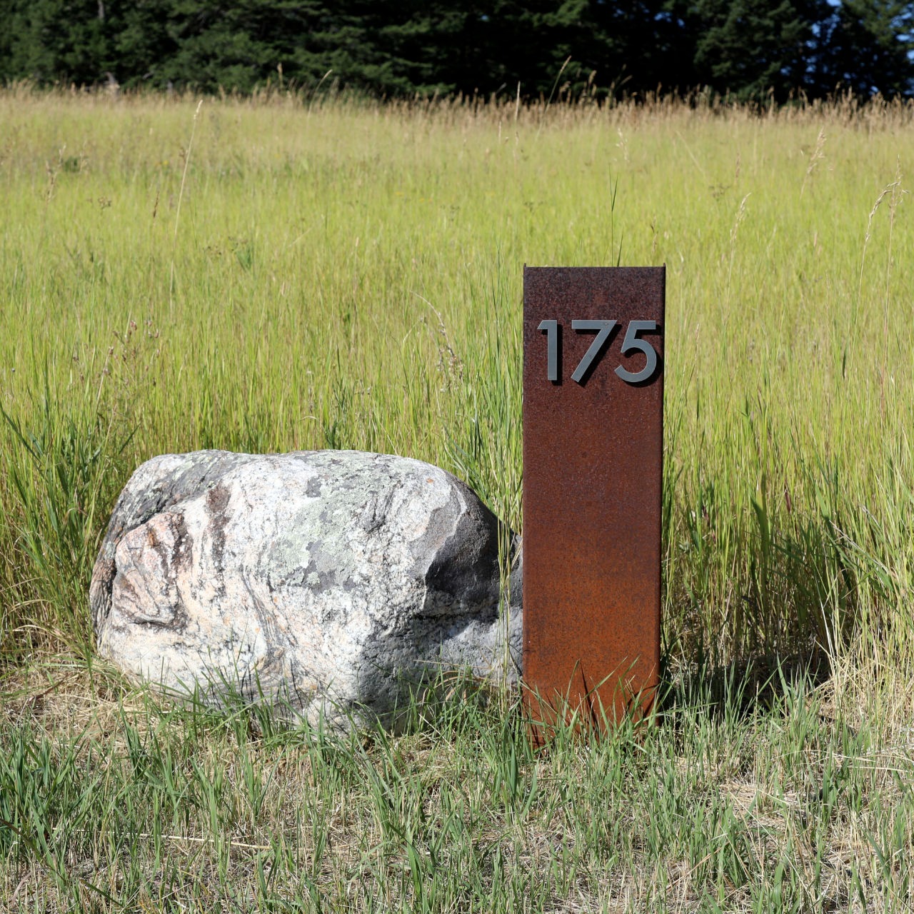 a stone and steel address marker