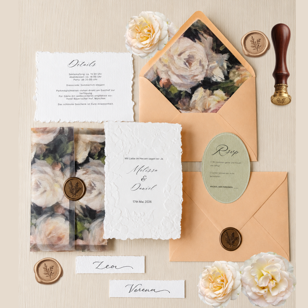Elegant floral wedding invitation suite with wax seals, peach envelopes, and deckled edge paper.