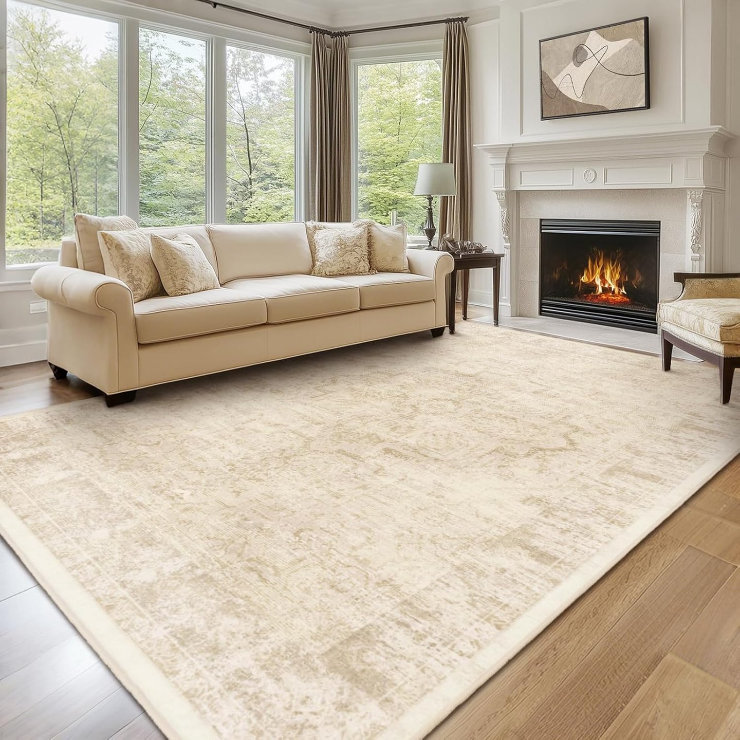 Elegant cream area rug in a modern living room with a fireplace, beige sofa, and large windows.