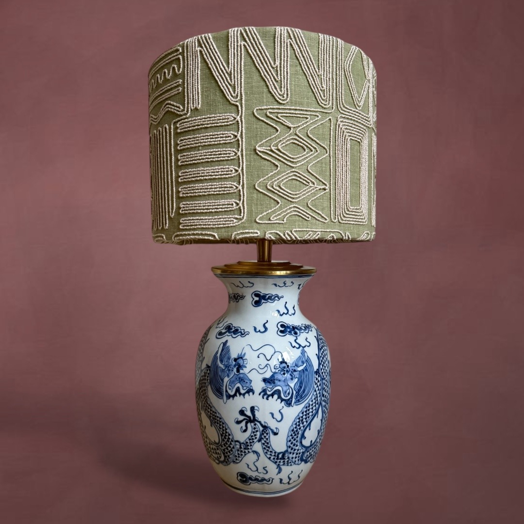 Vintage blue and white dragon porcelain table lamp with an embroidered sage green drum shade.