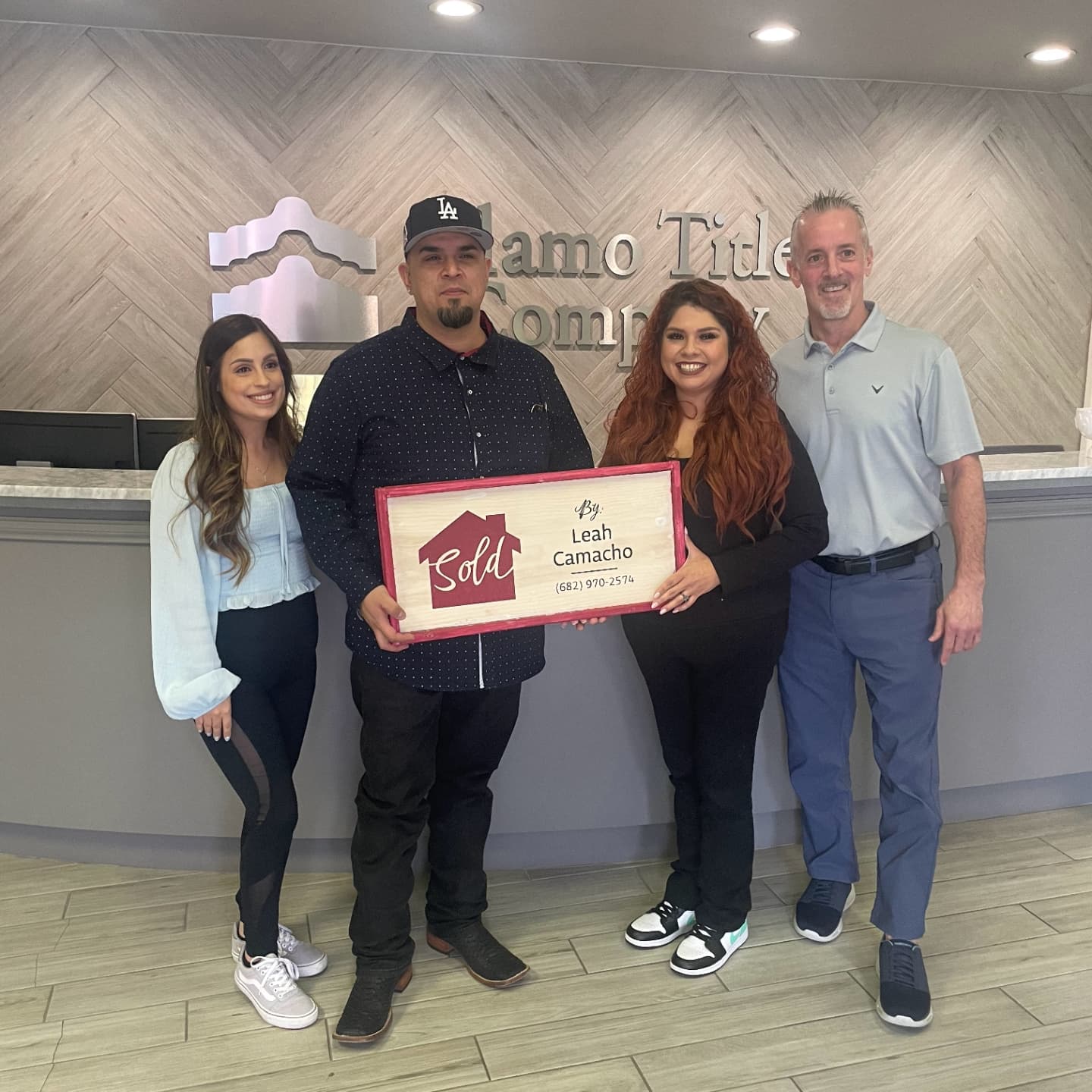 a man and woman standing in front of a sign that says,'welcome to