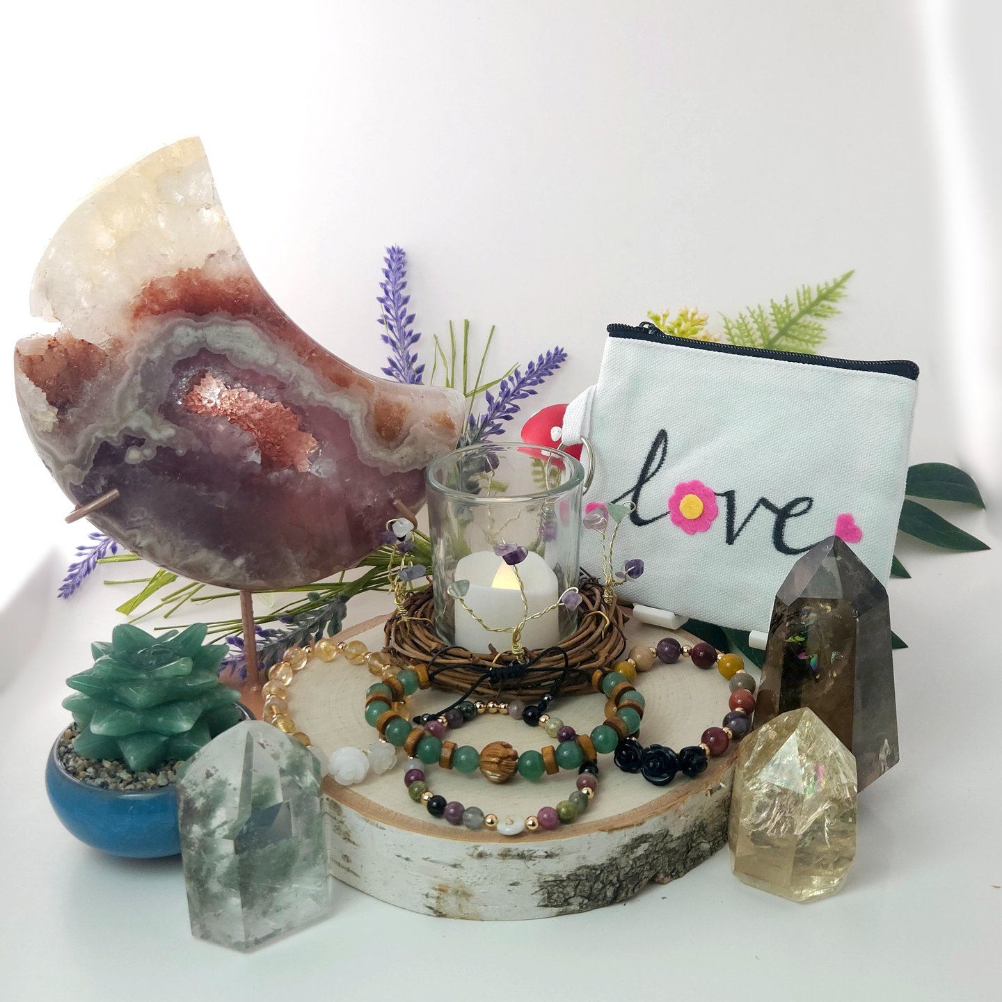 A collection of crystals, jewelry, and handmade decor