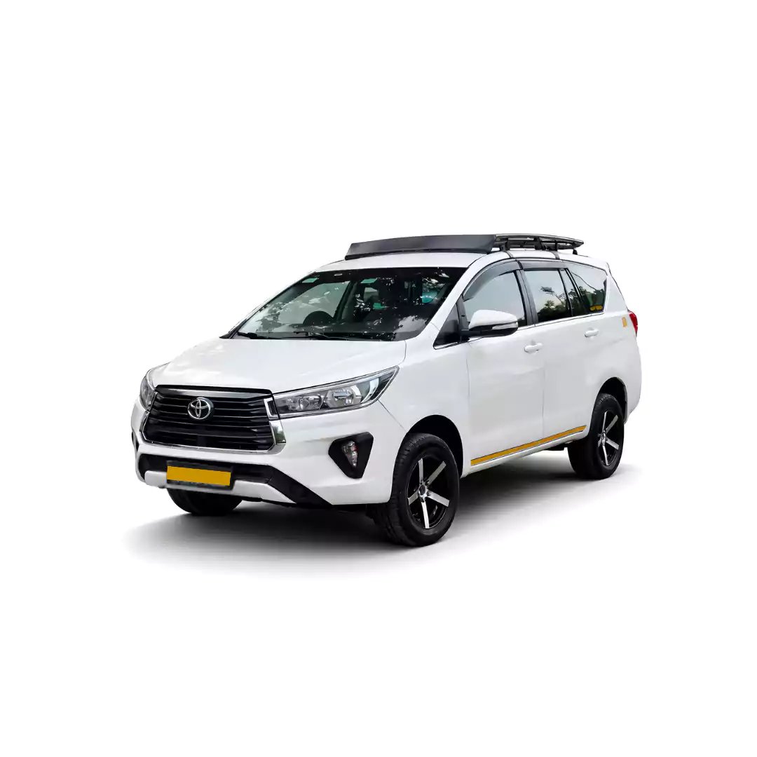 White Toyota Innova Crysta one way taxi by Saini taxi services with a luggage carrier rack