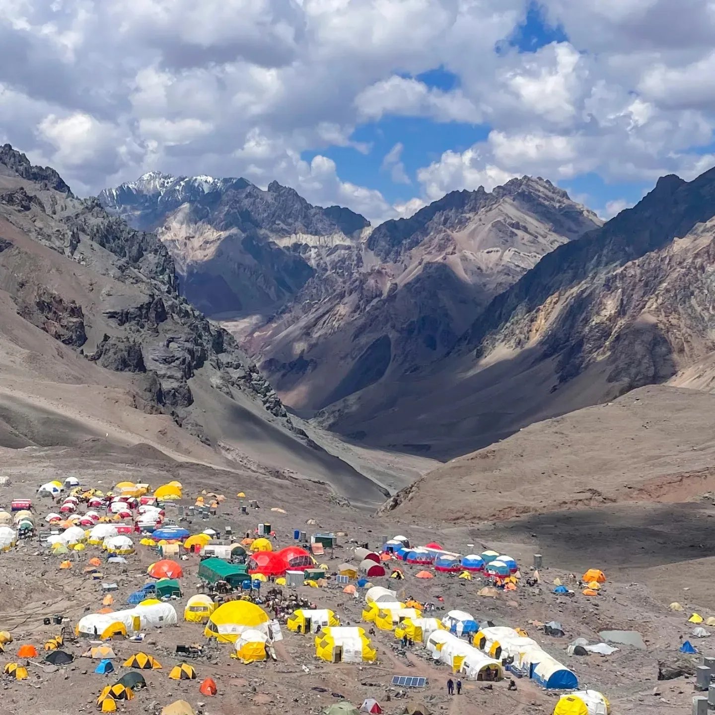 a mountain scene with tents and tents and tents