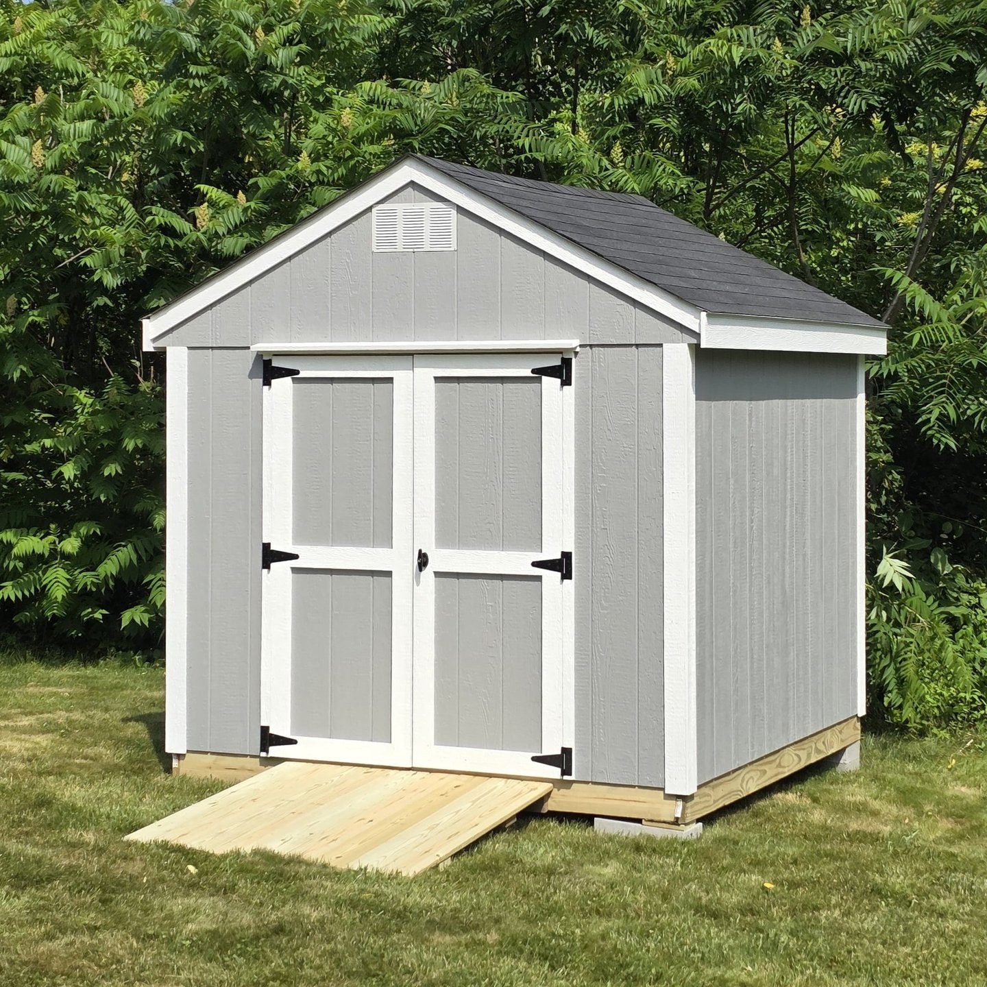 Custom wooden shed built in Massachusetts, perfect for garden tools and storage.