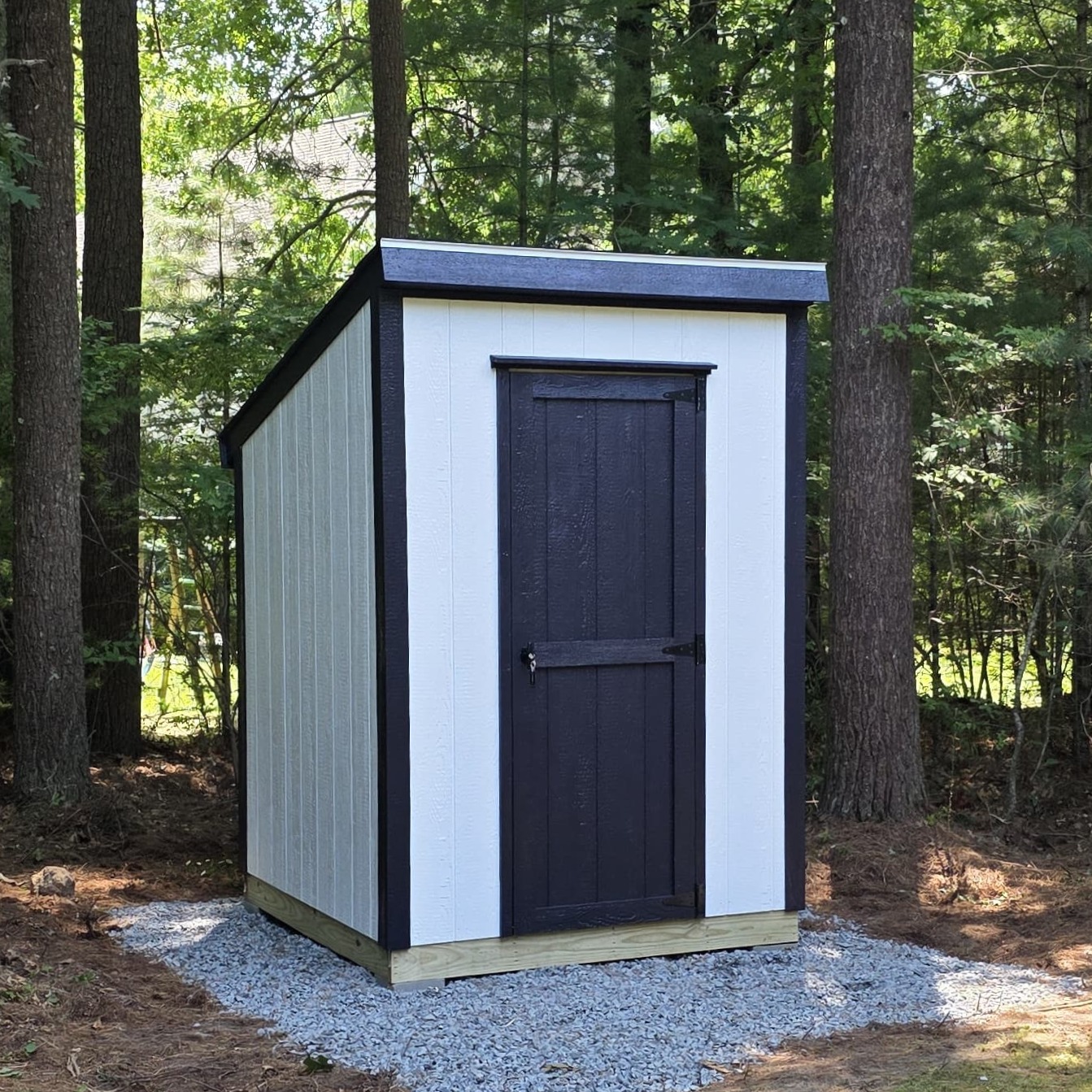 Compact 6x6 wooden storage shed with durable construction, ideal for small backyard spaces.