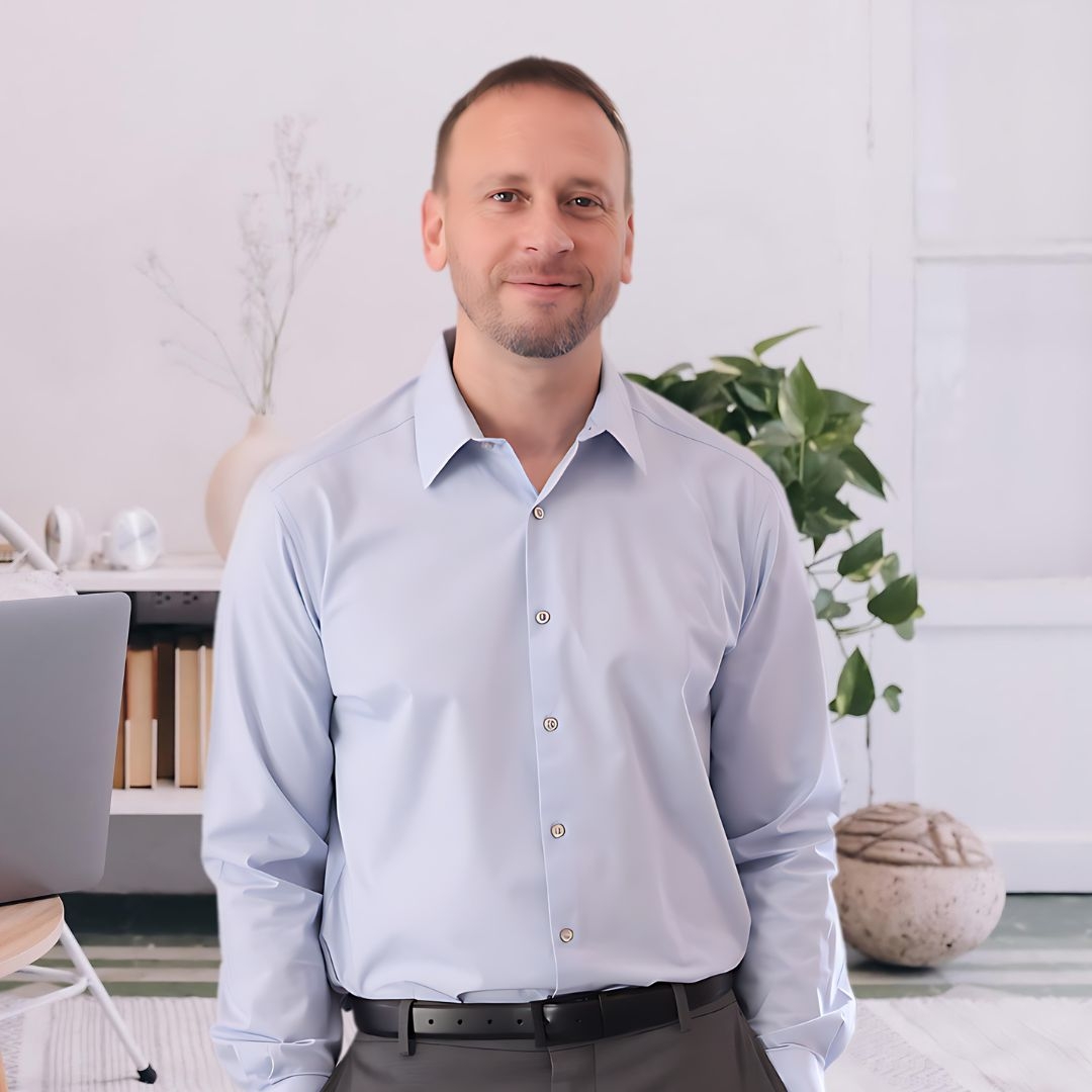 a man in a blue shirt and a laptop