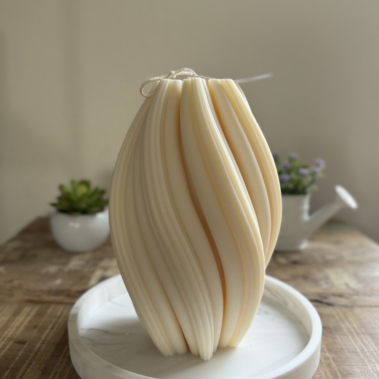 White twisted candle over a plate