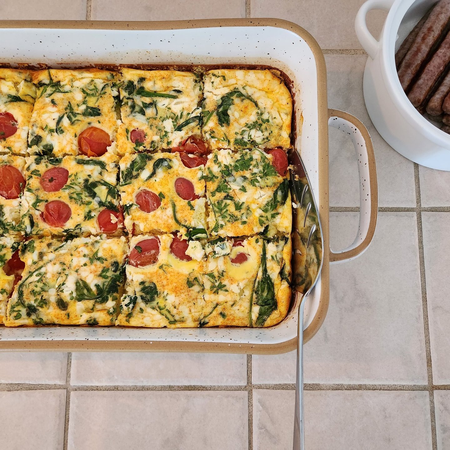 Two South Cliff Inn dishes, a vegetarian egg bake, with breakfast sausage on the side