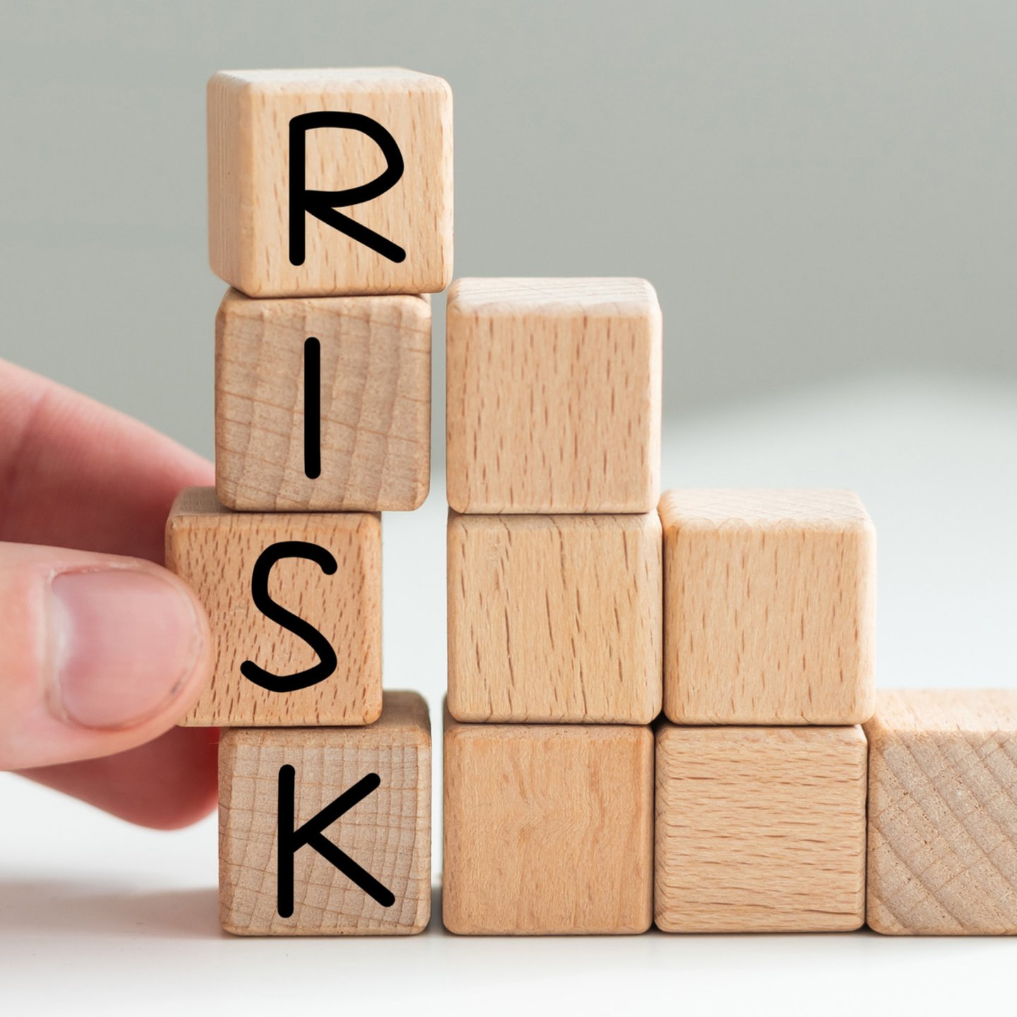 Game cube letters spell the work risk. Graphic supports the company-specific risk in valuations.