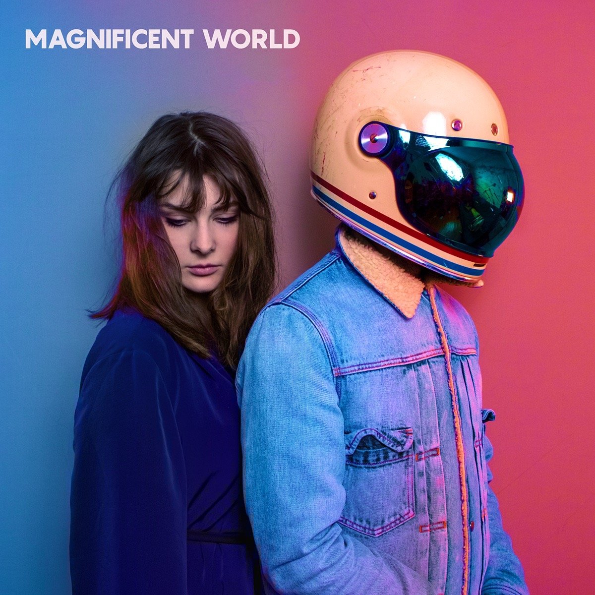 Album cover art for Magnificent World featuring a woman and a person in a vintage motorcycle helmet.