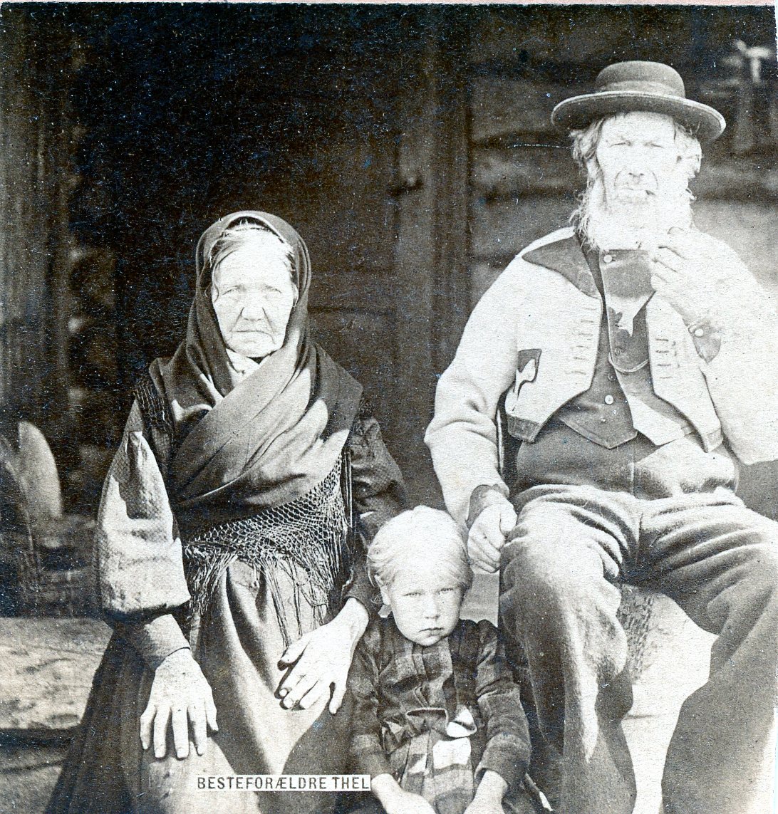 A black and white image of a man and a child in tradtitional costume