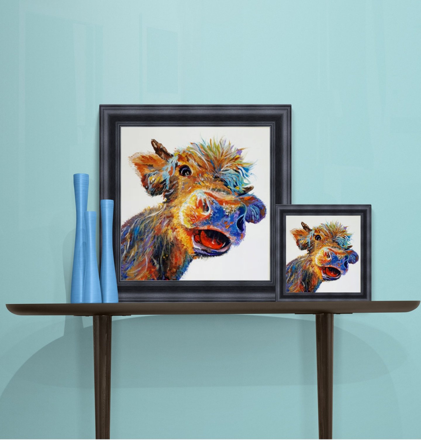 Two sizes of Hattie the happy cow in black frames