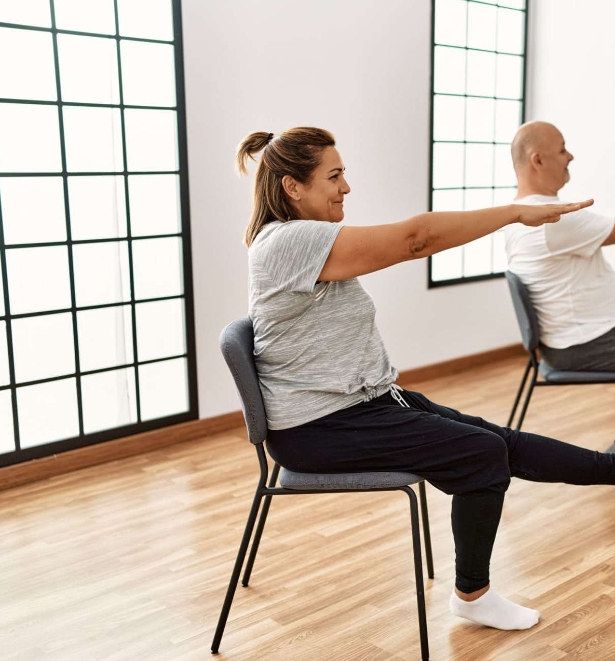 Chair yoga with arms and legs straight out to train core