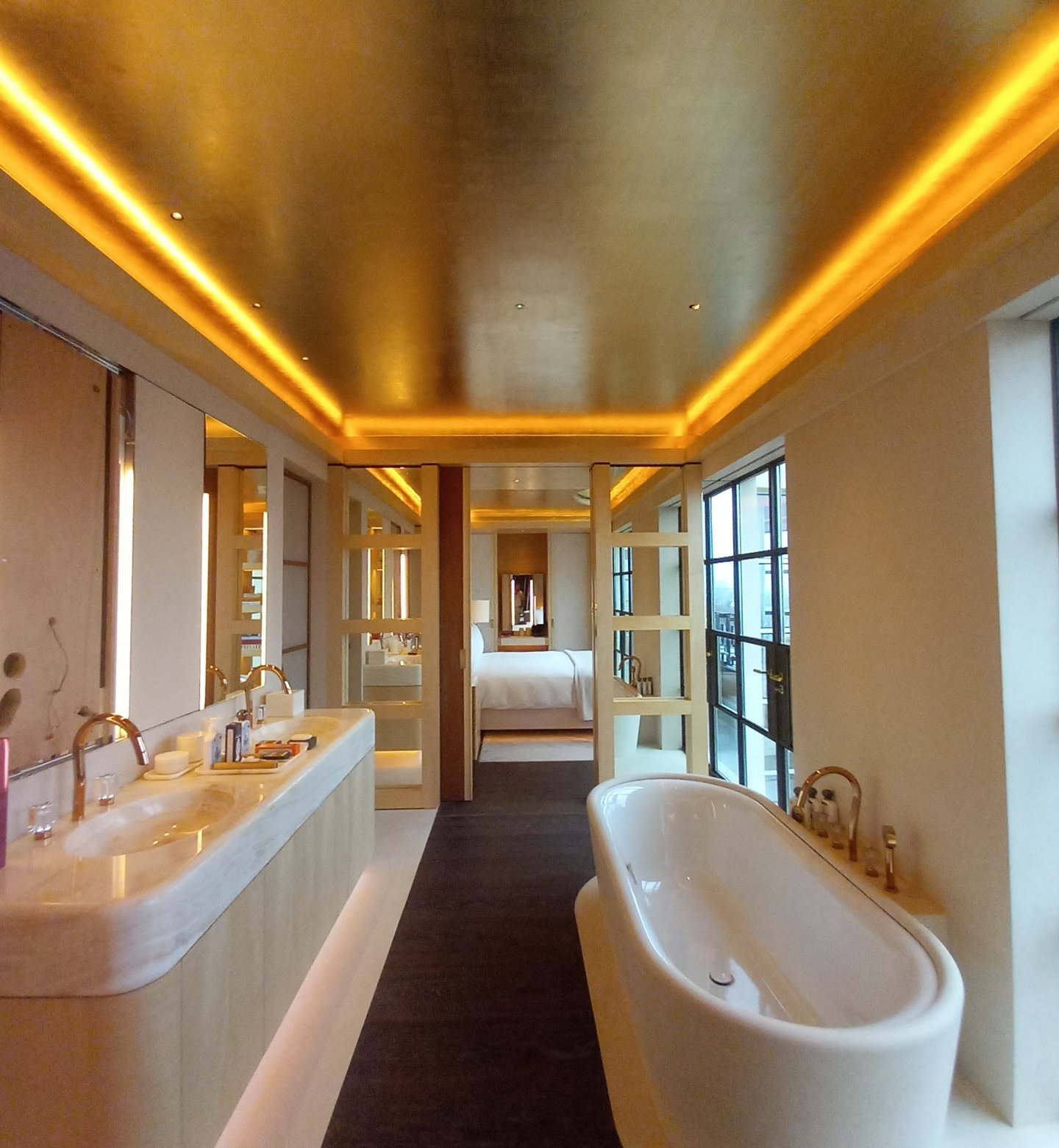 Luxury hotel master bathroom featuring a gilded ceiling