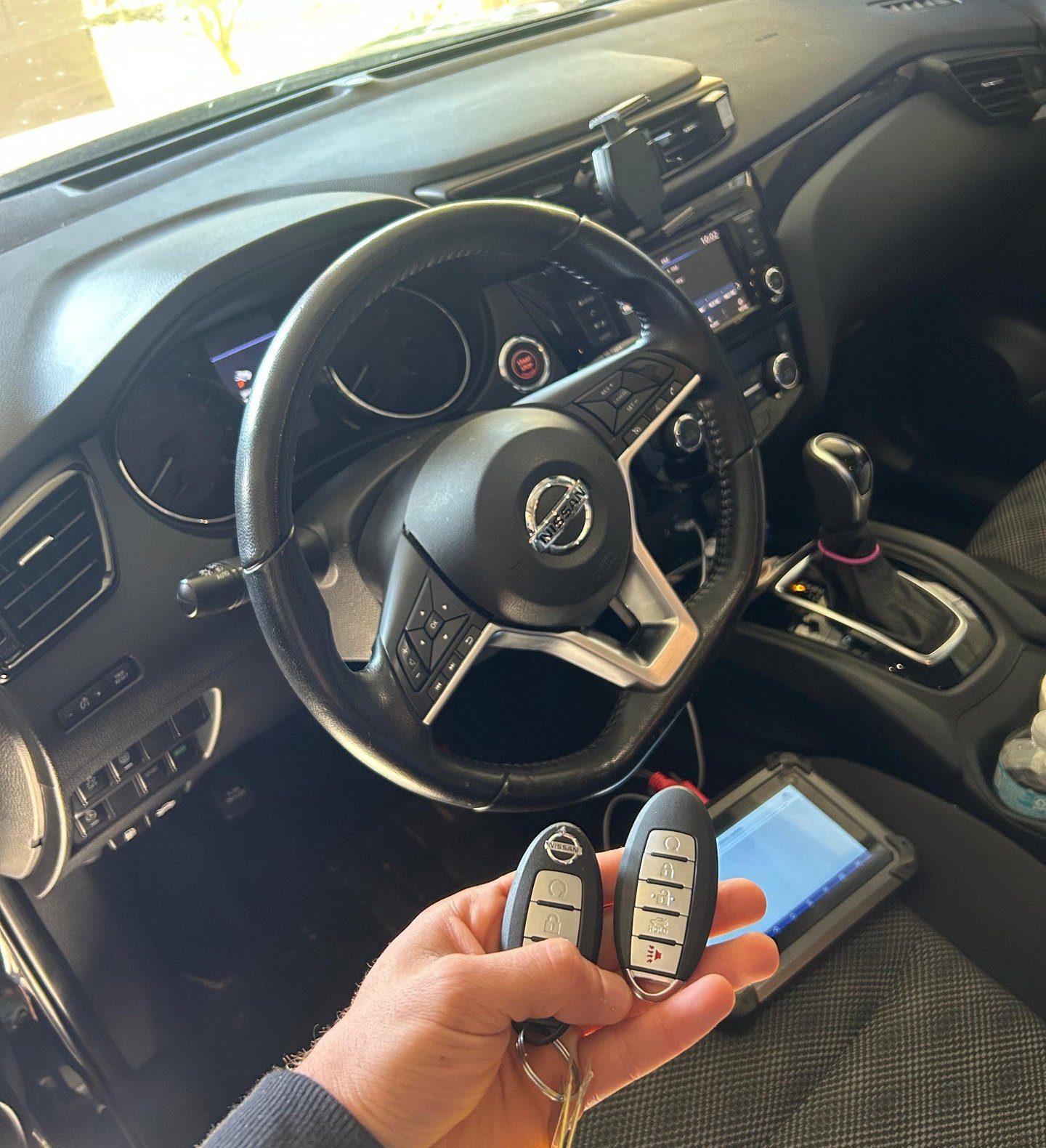 locksmith programming a car key fob on-site for a modern vehicle in Flagler County