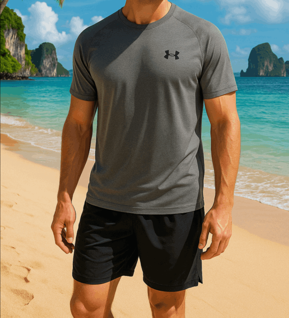 A man stands in front of the ocean wearing a grey Under Armour Mens Tech T-shirt