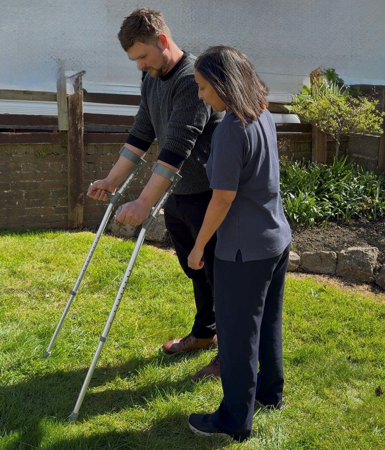 Home visiting physiotherapist in Cowbridge guiding patient during rehabilitation at home