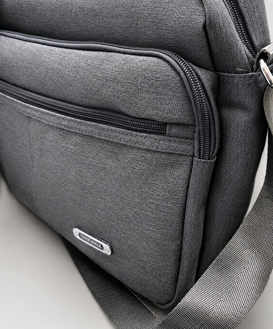 Custom metal label attached to a black fabric bag