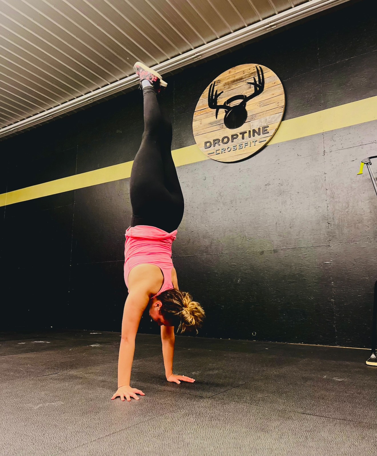 a woman doing a handstand on a gym floor