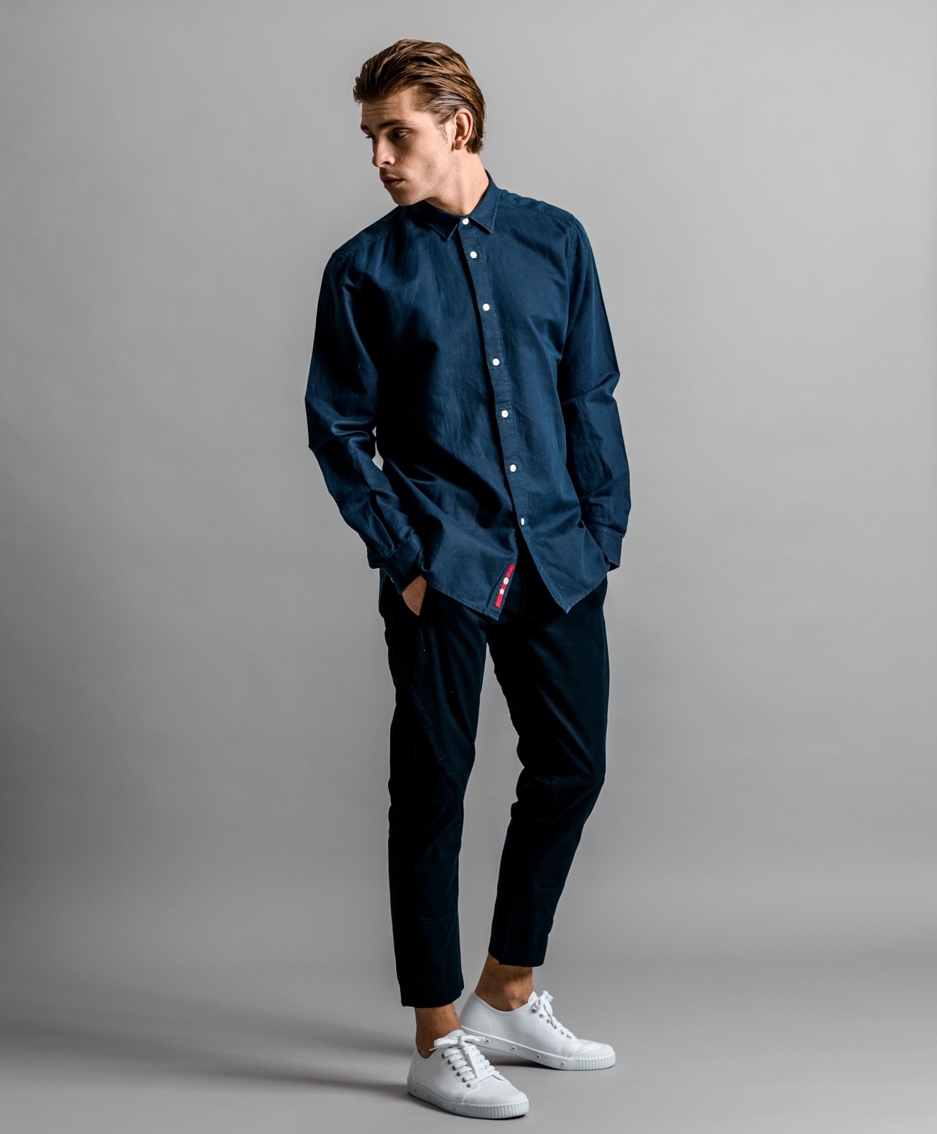 Fashion Photography - a man in a blue shirt and white sneakers