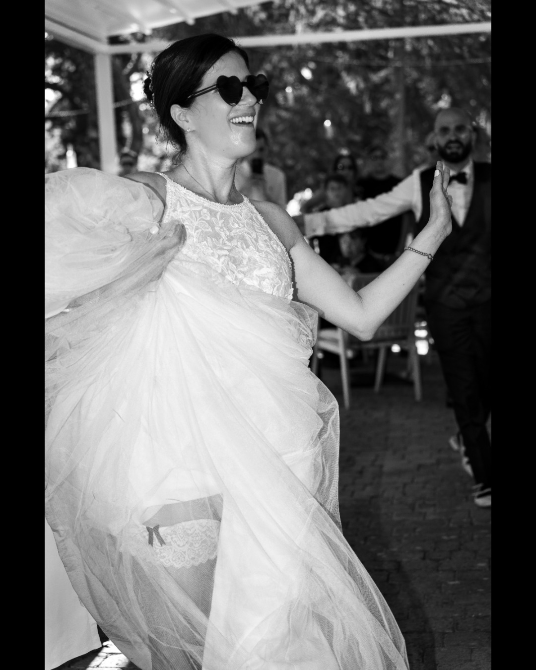 a woman in a wedding dress dancing with a man in a suit