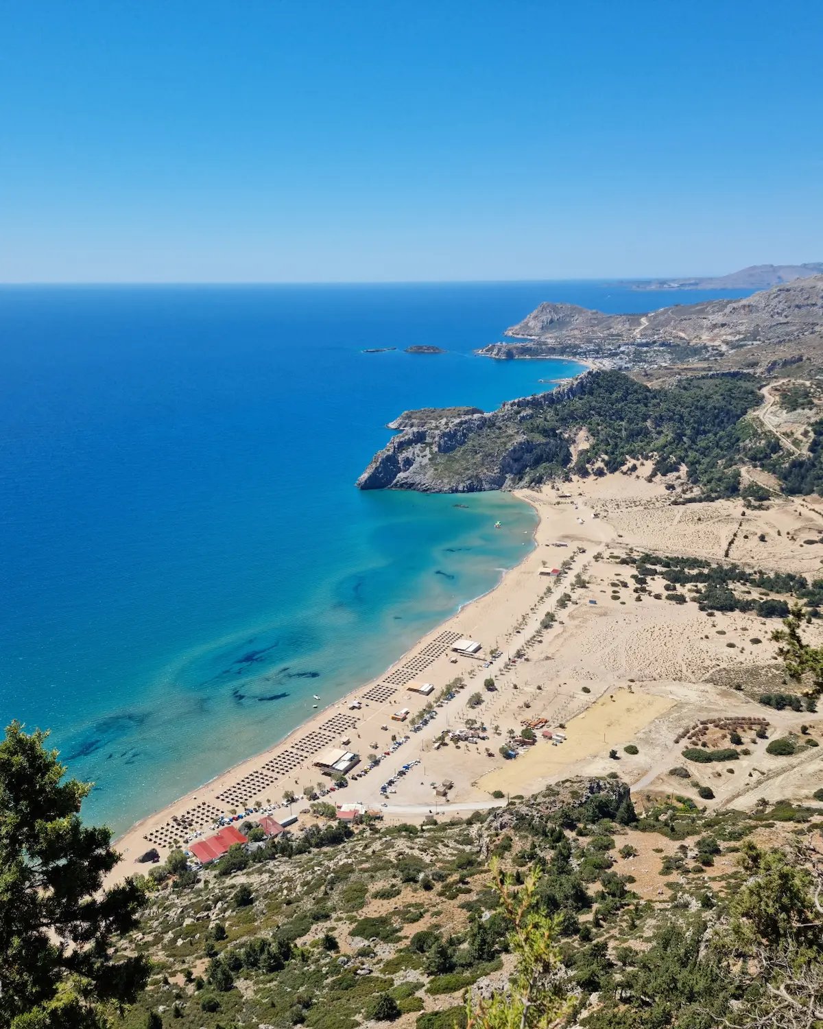 a beach with a sandy beach and a blue sky