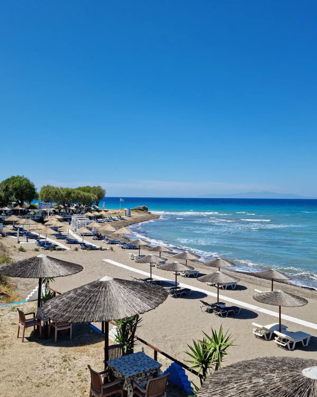 a beach with umbrellas and umbrellas on the beach