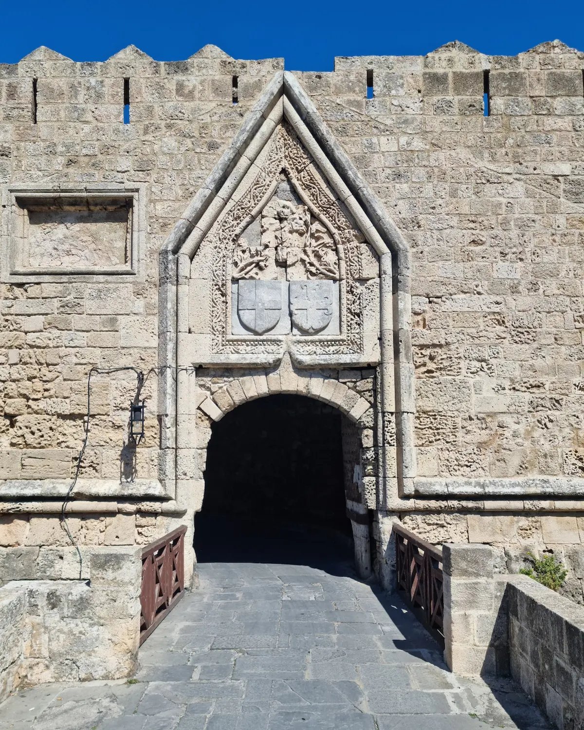 a stone wall with a stone archway and a stone wall