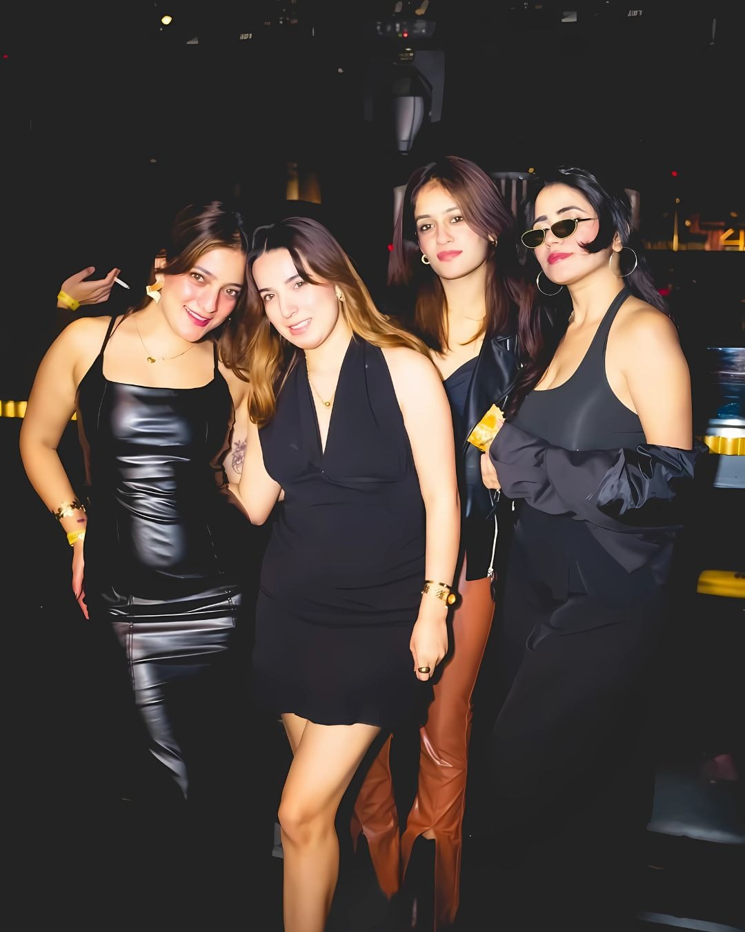a group of women in black dresses standing in a row