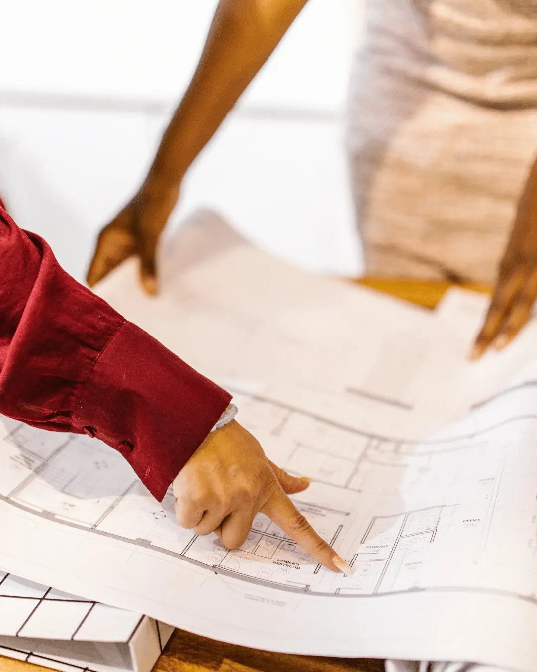 Home buyers reviewing a detailed floor plan before purchase