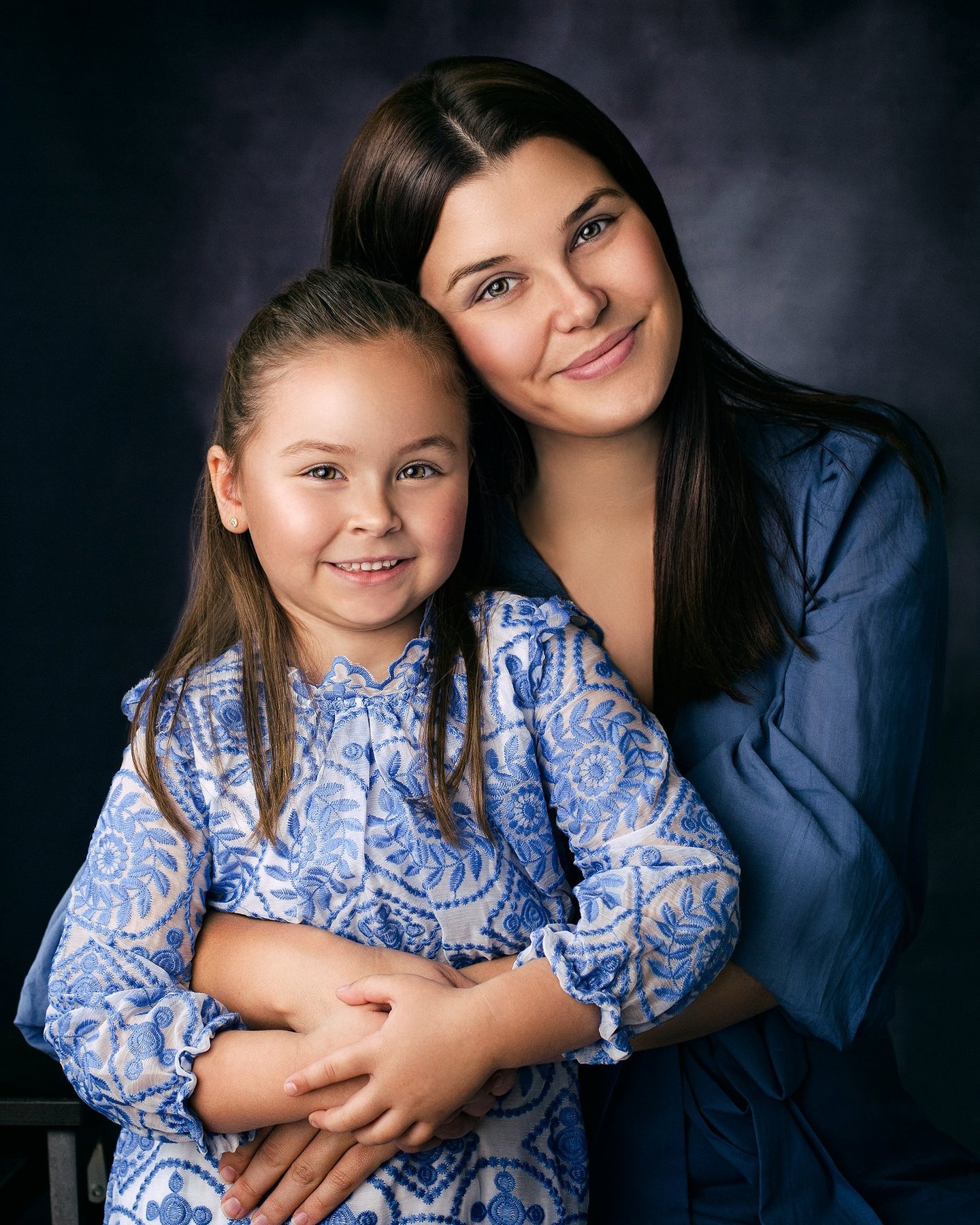 Mother and daughter embracing during a portrait session