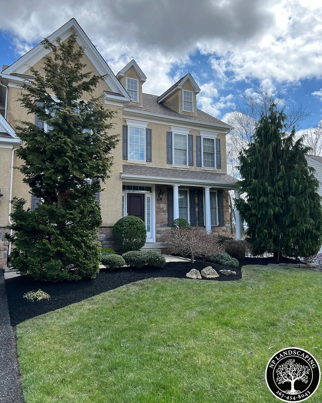 excellent landscaping and hardscaping of grass, stones and trees by NP Landscaping