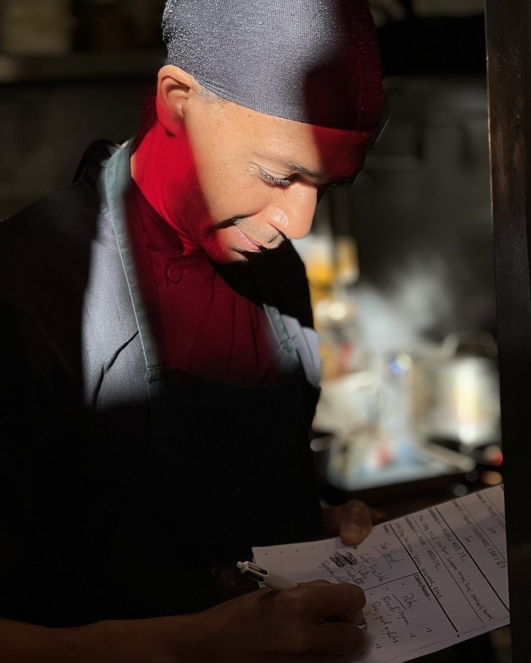a chef in a restaurant writing a menu