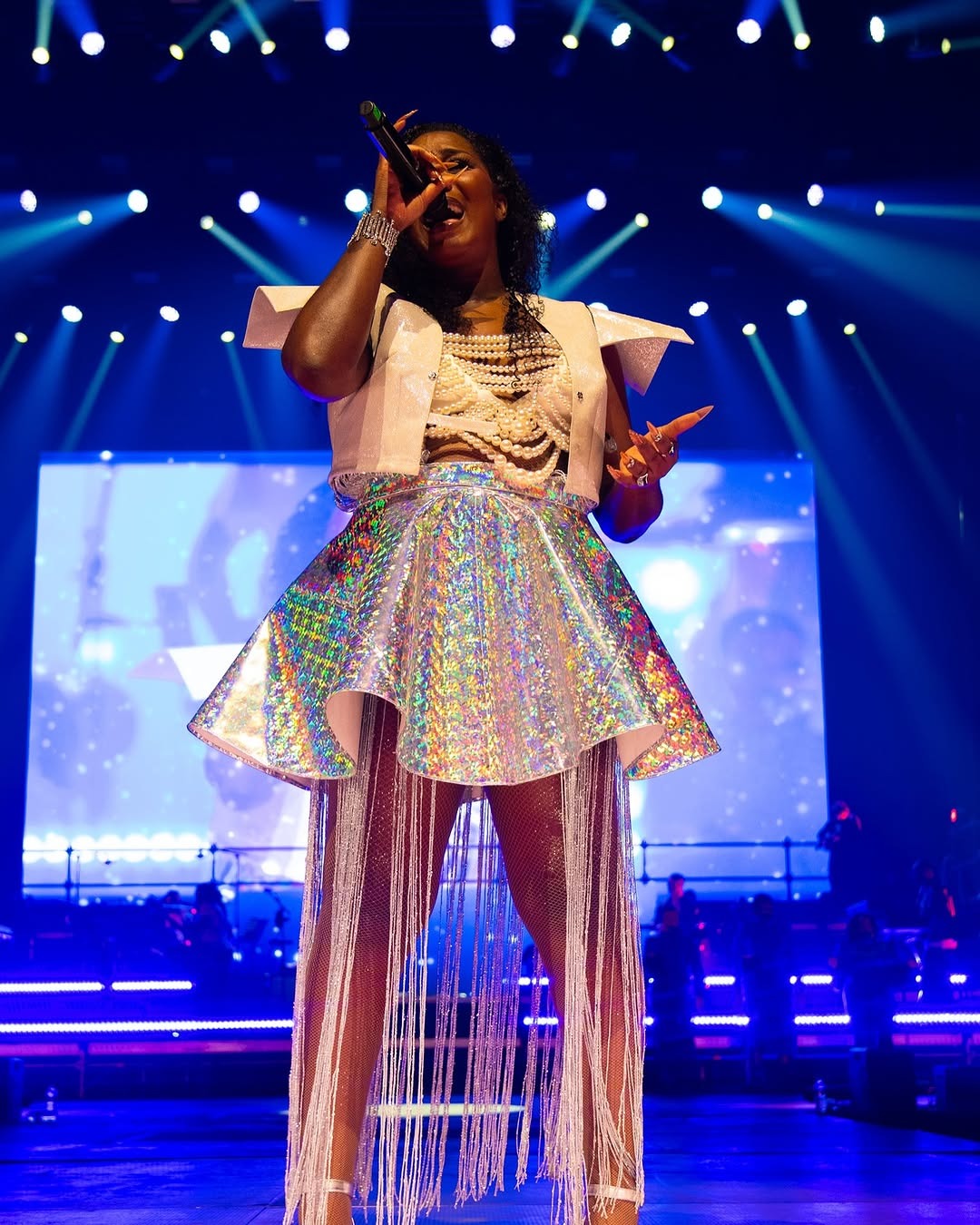 a woman in a white dress and a microphone