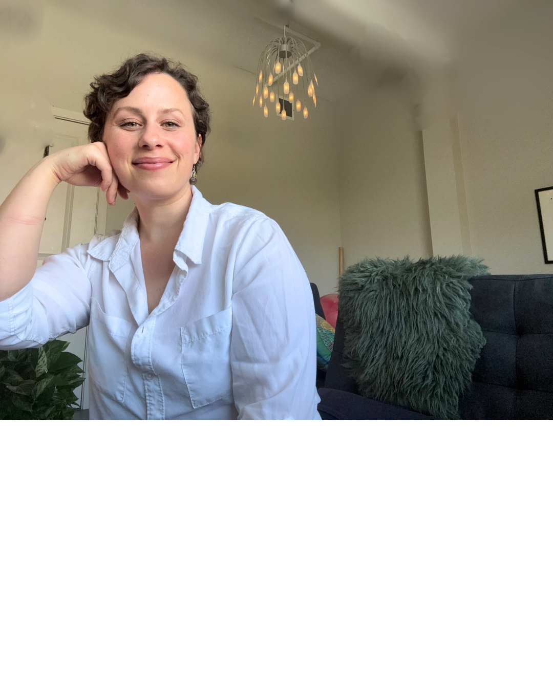 a woman in a white shirt and a black couch