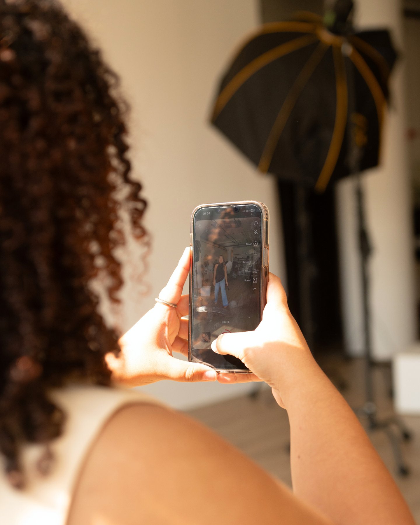 a woman holding a cell phone in her hand