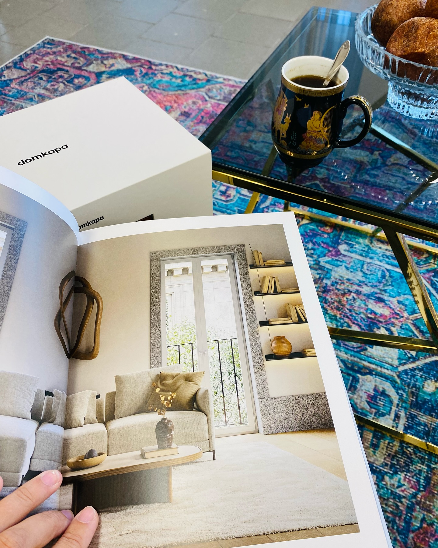 a person holding a book with a coffee cup
