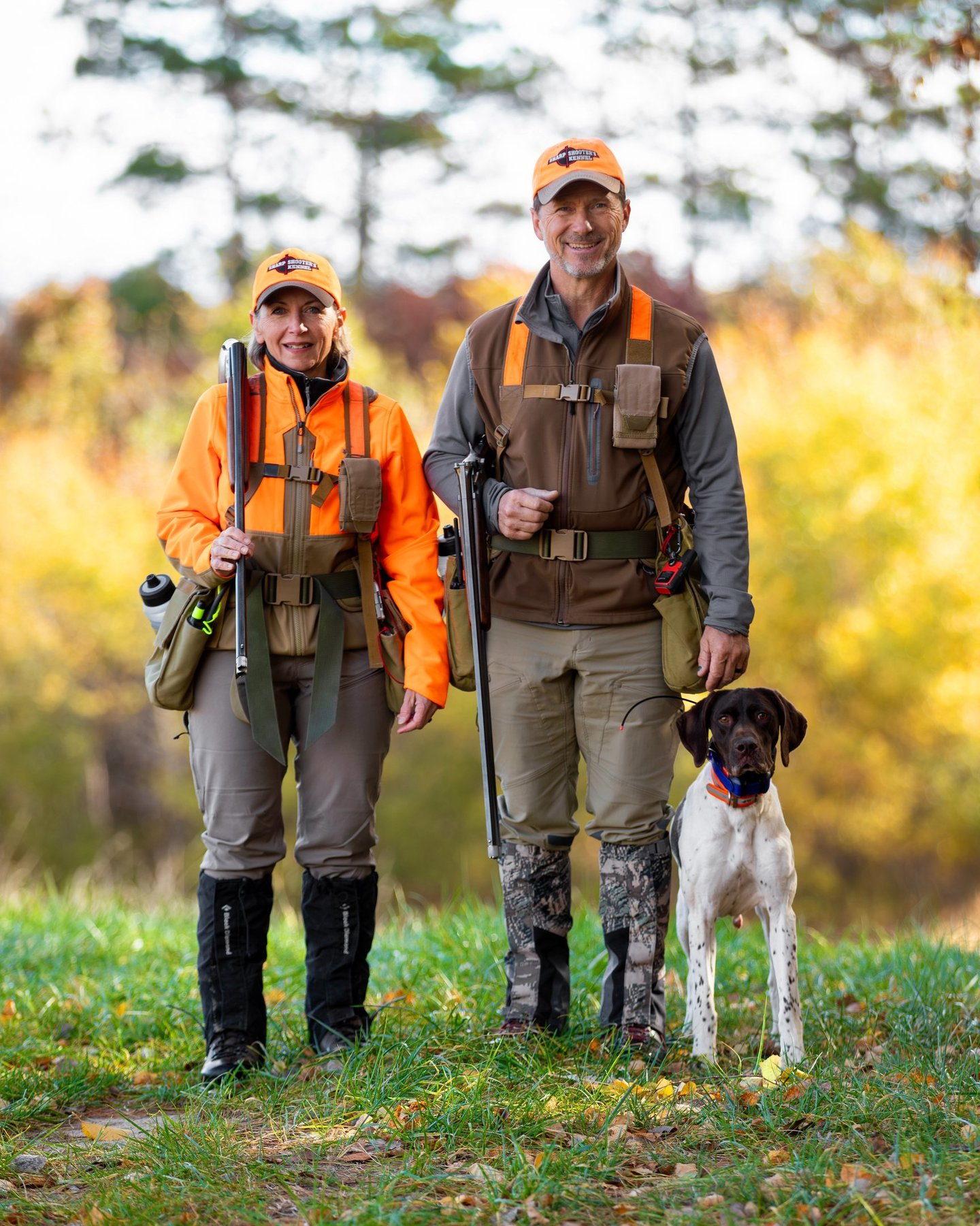 Kennel owners Clyde and Marilyn Vetter in the field with a dog.